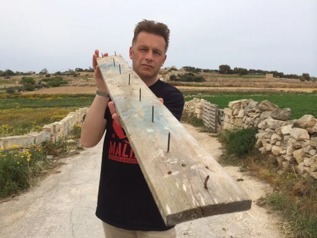 Chris Packham displays a nailed plank intended to burst the tyres of BirdLife Malta vehicles on the island. Photo: Chris Packham. Chris Packham displays a nailed plank intended to burst the tyres of BirdLife Malta vehicles on the island. Photo: Chris Packham.