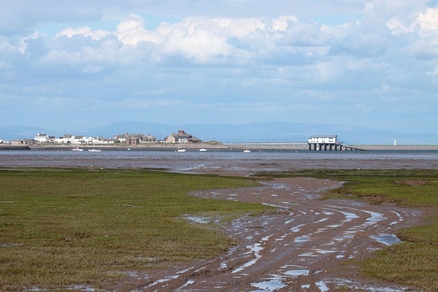 Viewed from Walney Island. Foulney Island, also, can be seen to the right behind the lifeboat station at Rampside. The white structure on the island is the Light Beacon. Viewed from Walney Island. Foulney Island, also, can be seen to the right behind the lifeboat station at Rampside. The white structure on the island is the Light Beacon.