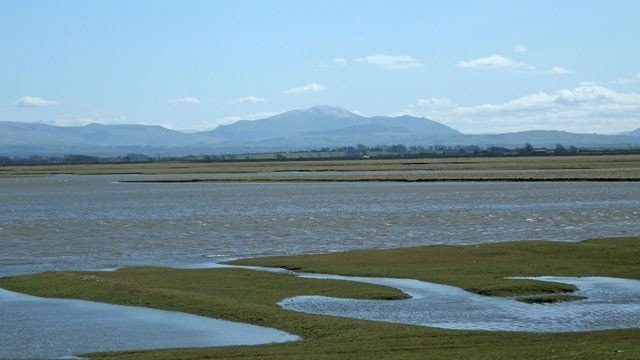 Looking across Skinburness Marsh to a distant Skiddaw from Grune Point at high tide. Looking across Skinburness Marsh to a distant Skiddaw from Grune Point at high tide.